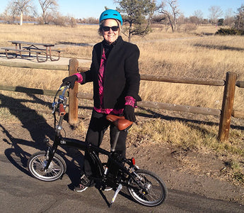 Kristine rides a Blix Electric foldable Vika travel bike
