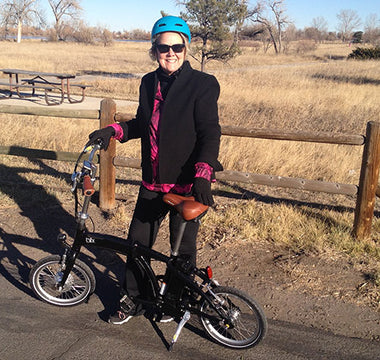 Kristine rides a Blix Electric foldable Vika travel bike